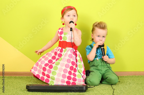 Photo: Mods girl and boy in bright clothes singing Mods girl and boy in bright clothes singing