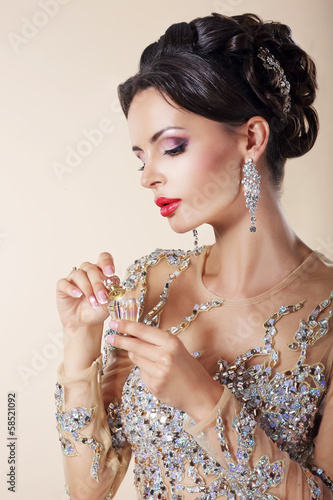 Photo: Portrait of Luxurious Caucasian Woman with Perfume Bottle. Portrait of Luxurious Caucasian Woman with Perfume Bottle.