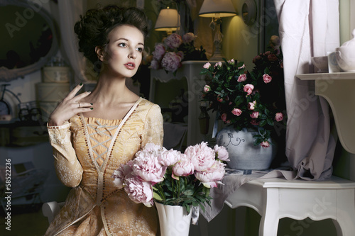 Photo: Girl in yellow retro dress with flowers Girl in yellow retro dress with flowers