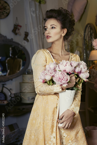 Photo: Girl in yellow retro dress with flowers Girl in yellow retro dress with flowers