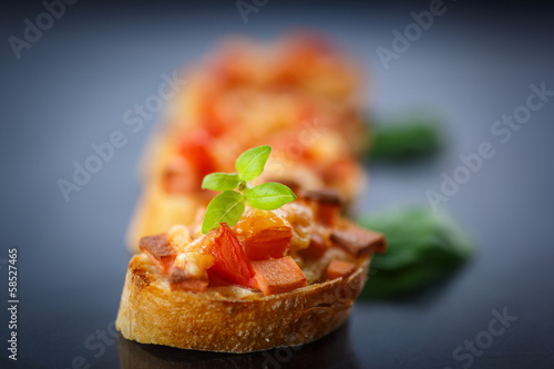 Photo: bruschetta with cheese and tomatoes bruschetta with cheese and tomatoes