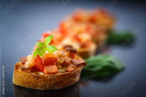 Photo: bruschetta with cheese and tomatoes bruschetta with cheese and tomatoes