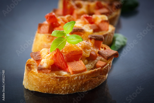 Photo: bruschetta with cheese and tomatoes bruschetta with cheese and tomatoes