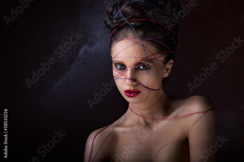 Photo: girl in a web of threads. girl in a web of threads.