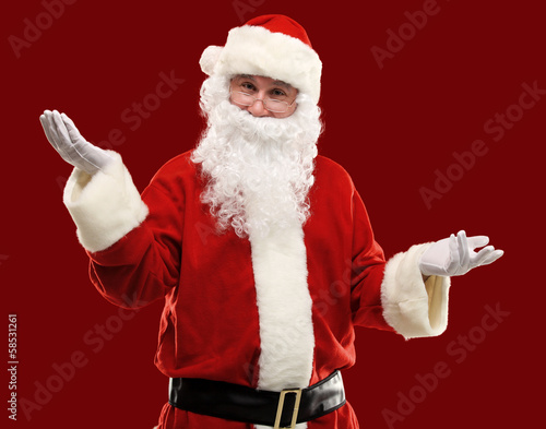 Photo: Santa Claus gesturing his hand isolated. Presenting something Santa Claus gesturing his hand isolated. Presenting something