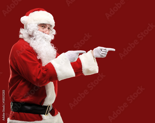 Photo: Santa Claus with his arms out in a presenting gesture Santa Claus with his arms out in a presenting gesture
