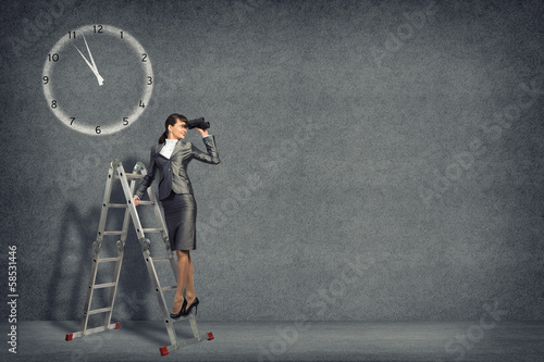 Photo: businesswoman looking through binoculars businesswoman looking through binoculars