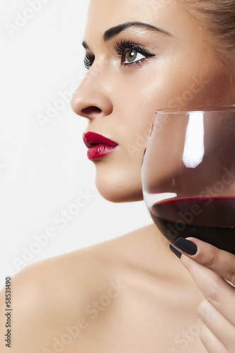Photo: Beautiful woman drinking red wine.red lips.wineglass Beautiful woman drinking red wine.red lips.wineglass
