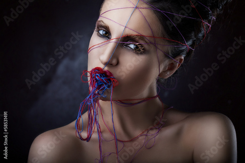 Photo: girl in a web of threads. girl in a web of threads.