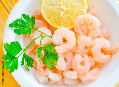 Photo: boiled shrimps in the white bowl on the table boiled shrimps in the white bowl on the table