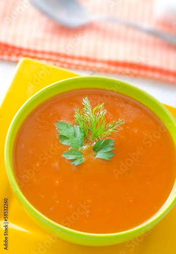 Photo: Fresh soup from pumpkin in the green bowl Fresh soup from pumpkin in the green bowl