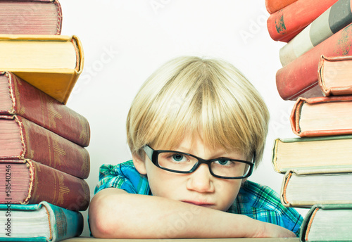 Photo: Boy with stack of books Boy with stack of books