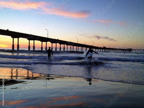 Instant Collection: Surfers at Sunset at Ocean Beach Pier San Diego California USA Surfers at Sunset at Ocean Beach Pier San Diego California USA