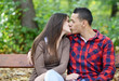 Couple kissing at the bench in park Couple kissing at the bench in park
