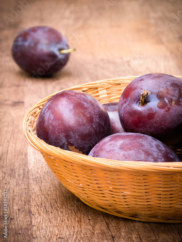Photo: Plums in Basket on Table Plums in Basket on Table
