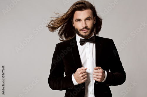 Photo: Portrait of handsome stylish man in elegant black suit Portrait of handsome stylish man in elegant black suit