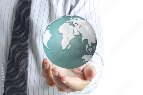 Photo: glowing earth globe in his hands glowing earth globe in his hands