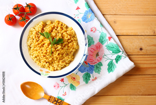 Photo: cooked wheat on wooden table cooked wheat on wooden table