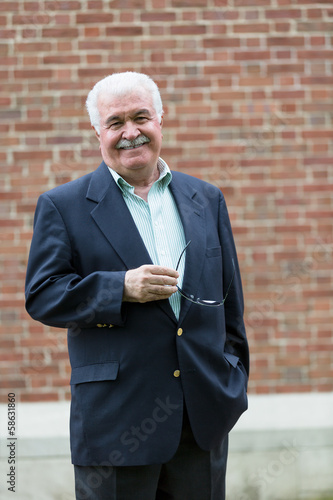 Photo: Friendly Senior Adult Looking at You Happily and Confidingly Friendly Senior Adult Looking at You Happily and Confidingly