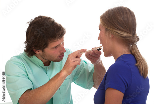 Photo: Laryngologist examining his patient Laryngologist examining his patient
