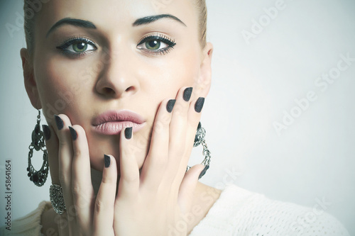 Photo: Beautiful woman in woolen dress.Jewelry and Beauty.manicure Beautiful woman in woolen dress.Jewelry and Beauty.manicure