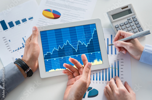 Photo: Businesspeople Analyzing Graph With Digital Tablet Businesspeople Analyzing Graph With Digital Tablet