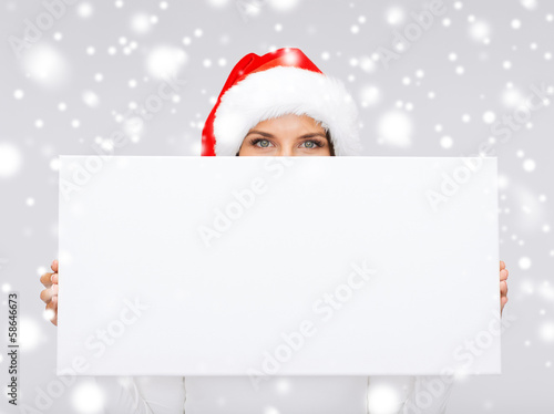 Photo: woman in santa helper hat with blank white board woman in santa helper hat with blank white board