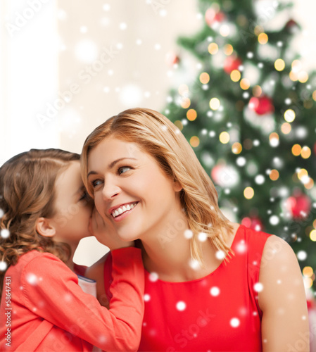 Photo: mother and daughter whispering gossip mother and daughter whispering gossip