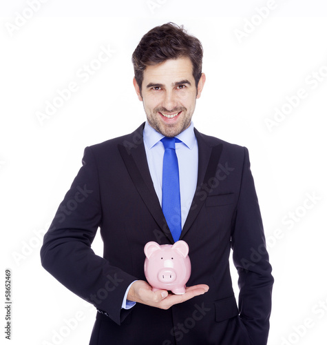 Photo: Handsome businessman holding a piggy bank, isolated on a white b Handsome businessman holding a piggy bank, isolated on a white b