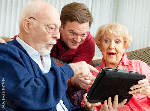 Photo: Seniors and Adult Son with Tablet PC Seniors and Adult Son with Tablet PC