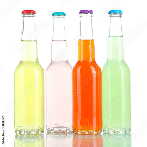 Photo: Drinks in glass bottles isolated on white Drinks in glass bottles isolated on white