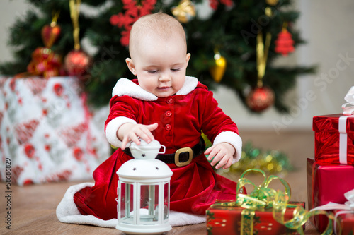Photo: Christmas baby girl with lamp Christmas baby girl with lamp