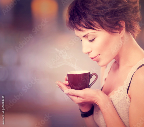 Photo: Coffee. Beautiful Girl Drinking Tea or Coffee Coffee. Beautiful Girl Drinking Tea or Coffee
