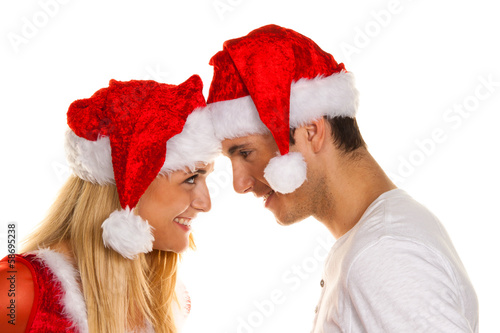 Photo: Paar zu Weihnachten mit Mützen des Weihnachtsmanne Paar zu Weihnachten mit Mützen des Weihnachtsmanne