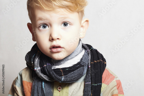 Photo: fashionable handsome little boy in scarf.stylish haircut.fashion fashionable handsome little boy in scarf.stylish haircut.fashion