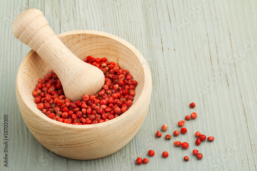 Photo: mortar and pestle with red peppercorns mortar and pestle with red peppercorns