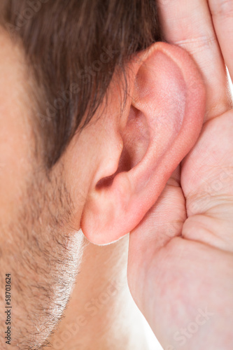 Photo: Close-up Of Hand Near Ear Close-up Of Hand Near Ear