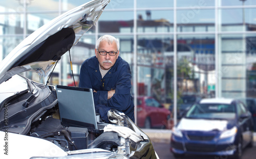 Photo: Mature auto mechanic. Mature auto mechanic.