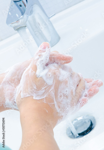 Photo: Washing of hands with soap under running water Washing of hands with soap under running water