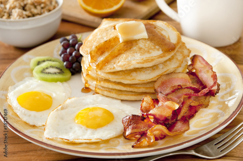 Photo: breakfast plate with pancakes, eggs, bacon and fruit. breakfast plate with pancakes, eggs, bacon and fruit.