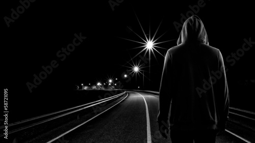 Photo: Teenager boy standing alone in the street at night Teenager boy standing alone in the street at night