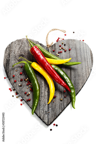 Photo: Fresh vegetables on heart shaped cutting board Fresh vegetables on heart shaped cutting board