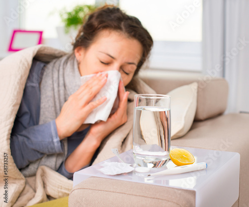 Photo: Sick Woman. Flu. Woman Caught Cold. Sneezing into Tissue Sick Woman. Flu. Woman Caught Cold. Sneezing into Tissue