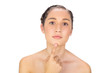 Natural model pointing at her chin Natural model pointing at her chin