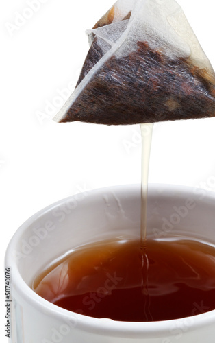Photo: removing of tea bag from mug with brewing tea removing of tea bag from mug with brewing tea