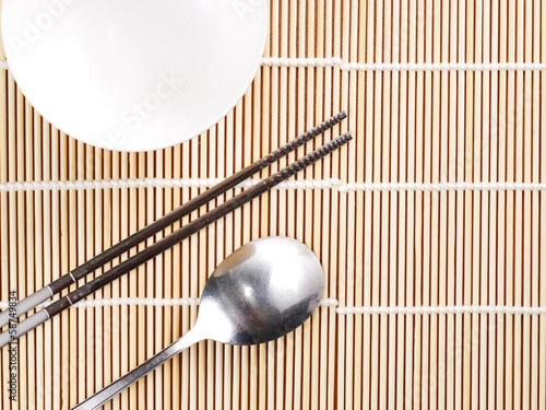 Photo: Asian dish place setting on bamboo mat, Korean style Asian dish place setting on bamboo mat, Korean style