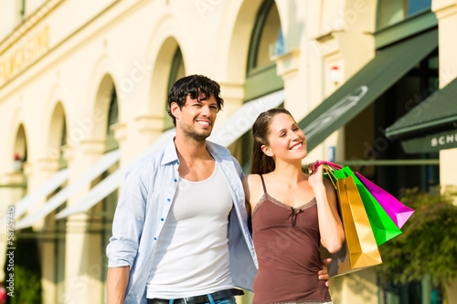 Photo: Couple shopping and spending money in city Couple shopping and spending money in city