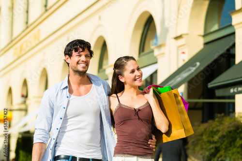 Photo: Couple shopping and spending money in city Couple shopping and spending money in city