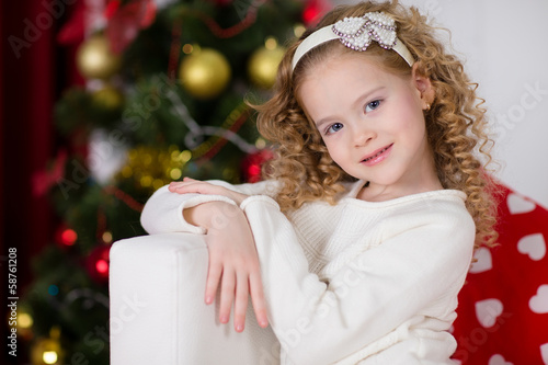 Photo: Portrait of smiling cute girl with Christmas gift Portrait of smiling cute girl with Christmas gift