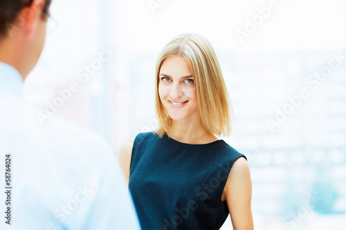 Photo: Two young business collegues. Two young business collegues.